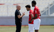 Winston Muscat (left), head coach of Naxxar Lions, talks to two substitute players during...