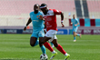 Louis Mvemba Ndualu Pahama of Naxxar Lions is closely followed by N'SA Chrisnovic Isemoli...