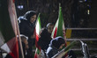 Young Iranian women holding national flags participate in a pro-government rally in downto...