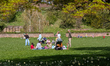 Visitors sit, stand, and spend time on a meadow at Killesberg Park in Stuttgart, Baden-Wue...