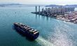 A cargo ship loaded with foreign trade containers departs from the port of Qingdao, Shando...