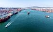 A cargo ship carrying foreign trade containers enters and exits Qingdao Port in Shandong P...