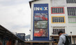 A man stands near a poster of the Indian Hindi-language spy action thriller film ''Dhurand...