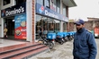 A security guard stands outside a Domino's restaurant in Srinagar, Jammu and Kashmir, Indi...