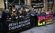 Jewish leaders, local elected officials, and supporters stage a protest outside the office...