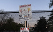 Demonstrators carrying anti-war signs gather outside the White House in Washington, D.C.,...