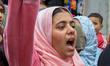 A Shiite Muslim girl shouts slogans and expresses solidarity with Iran on the outskirts of...
