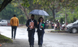 People walk with umbrellas during rainfall in Kathmandu, Nepal, on April 8, 2026, as a wes...