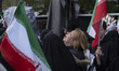 An unidentified Iranian woman mourns during a gathering in downtown Tehran, Iran, held by...