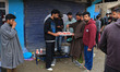Kashmiri Shia men serve tea to pedestrians in the Bemina area of Srinagar, Kashmir, on Apr...