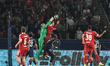 Paris Saint-Germain goalkeeper Matvey Safonov punches clear from Virgil van Dijk of Liverp...