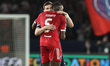 Ibrahima Konate of Liverpool embraces Khvicha Kvaratskhelia of Paris Saint-Germain during...