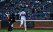 Luis Robert Jr. #88 of the New York Mets scores on a sacrifice fly during the eighth innin...