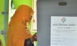 A woman casts her ballot at a polling station during the Assam Legislative Assembly electi...