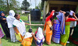 Voters stand in queues to cast their ballots at a polling booth during the Assam Legislati...