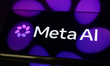 The new Meta AI logo is displayed on a smartphone screen placed on a reflective surface on...