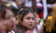 Nepali artists from the Newa: community perform with the Dhime, a traditional double-heade...