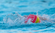 The official World Aquatics water polo ball is partially submerged during the World Aquati...