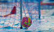 The official World Aquatics water polo ball is nestled in a goalpost net during the World...