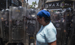 Opponents of interim President Delcy Rodriguez's government clash with police during a dem...