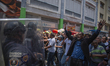 Opponents of interim President Delcy Rodriguez's government clash with police during a dem...