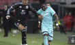 Jonathan Rowe of Bologna FC competes for the ball with Morgan Rogers of Aston Villa FC dur...