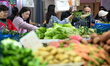 Customers purchase vegetables at a farmer's market in Nanjing, Jiangsu Province, China, on...