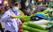 Customers purchase vegetables at a farmer's market in Nanjing, Jiangsu Province, China, on...