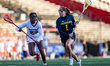 Ceci Stein of the Michigan Wolverines drives the ball against Charlee Thomas of the Rutger...