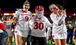 Caroline Ling, Ellie Racki, and Kate Theofield of the Rutgers Scarlet Knights celebrate af...