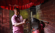 A priest applies the first touches of clay to the idol of Rato Machhindranath at Tabahal M...