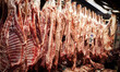 Lamb carcasses hang on display at a butcher stall inside the Varvakios Central Municipal M...