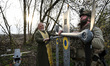Military chaplain Father Stepan assists a soldier in assembling a drone before its launch...