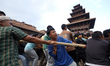 Nepali revelers pull the chariot of Lord Bhairav, marking the beginning of the eight-night...