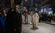 Greek Christian Orthodox worshippers participate in the Good Friday procession known as th...