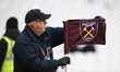 A groundsman checks the corner flag prior to the Premier League match between West Ham Uni...