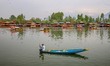 A boatman collects garbage and plastic waste from the waters of Dal Lake in Srinagar, Jamm...