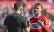 Referee Thomas Kirk talks with Tommy Conway of Middlesbrough during the Sky Bet Championsh...