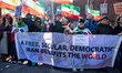 Protesters carry a banner reading ''A FREE, SECULAR, DEMOCRATIC IRAN BENEFITS THE WORLD''...