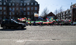 A car drives past as people gather during a protest against the government of Iran outside...