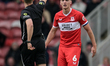 Dael Fry of Middlesbrough FC receives a yellow card from match referee Tom Kirk during the...
