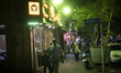 People walk along a sidewalk in downtown Tehran, Iran, on April 11, 2026, amid Iran-United...