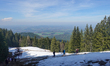 Hikers walk across snow patches and mountain trails near Neureuth and Gindelalmschneid in...