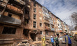 Volunteers and emergency services work at an apartment block following a reported drone st...