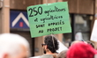 People demonstrate with a sign in Chambery, France, against the SNCF Lyon-Turin railway pr...