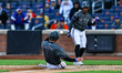 New York Mets player Carson Benge #3 scores on a sacrifice fly during the sixth inning of...