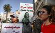 A demonstrator holds a placard in Arabic reading ''Free Saadia Mosbah,'' featuring a portr...