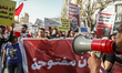 Tunisians hold up placards during a march organized by the Campaign Against the Criminaliz...