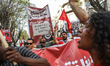 A protester holds a placard reading, ''No justice in a racism system,'' while shouting slo...