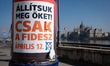 A lower fragment of a Fidesz campaign poster is seen on a cylindrical advertising column o...